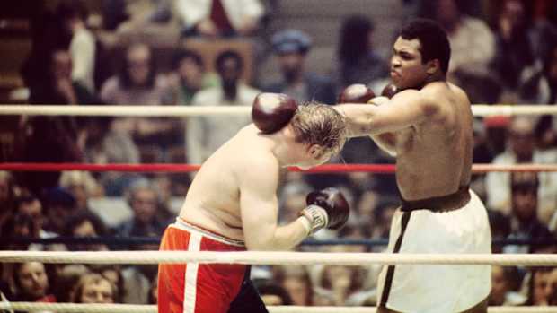 Cassius Clay aka Muhammad Ali (white trunks) fights Chuck Wepner (red/blue trunks) during their world heavyweight championship bout at Richfield Coliseum
